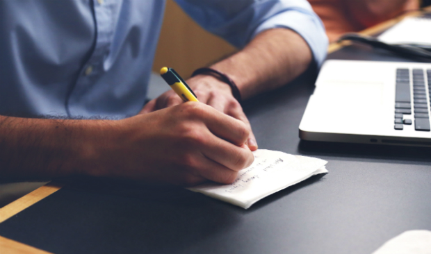 Image of male writing on paper